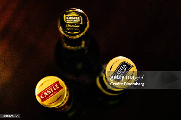 Branded bottle caps for Castle lager, Castle Milk Stout and Castle Milk Stout Chocolate beers sit in the sample room in this arranged photograph at...