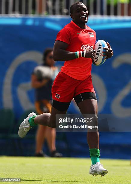 Willie Ambaka of Kenya breaks through to score a try during the Men's Rugby Sevens placing 11-12 match between Brazil and Kenya on Day 6 of the Rio...