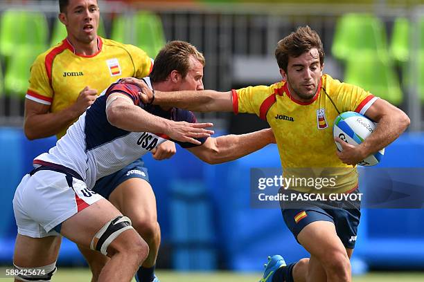 Spain's Angel Lopez is tackled by USA's Ben Pinkelman in the mens rugby sevens match between USA and Spain during the Rio 2016 Olympic Games at...