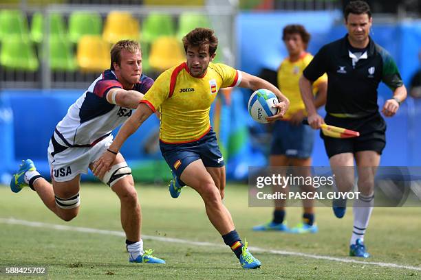 Spain's Angel Lopez is tackled by USA's Ben Pinkelman in the mens rugby sevens match between USA and Spain during the Rio 2016 Olympic Games at...