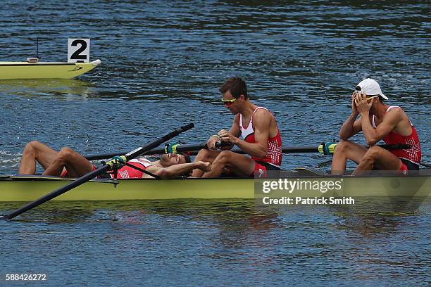 Mario Gyr, Simon Niepmann, and Simon Schuerch of Switzerland celebrate after winning the gold medal in the Lightweight Men's Four Final A on Day 6 of...