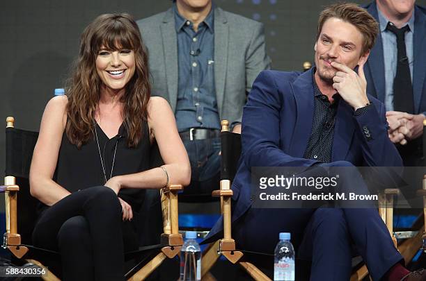 Actors Devin Kelley and Riley Smith speak onstage at the 'Frequency' panel discussion during The CW portion of the 2016 Television Critics...