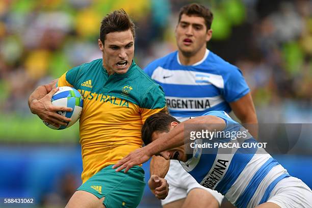 Australia's Ed Jenkins is tackled in the mens rugby sevens match between Argentina and Australia during the Rio 2016 Olympic Games at Deodoro Stadium...