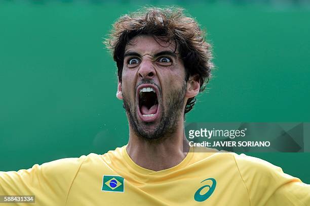 Brazil's Thomaz Bellucci celebrates after winning against Belgium's David Goffin during their men's singles third round tennis match at the Olympic...