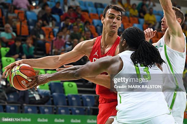 Brazil's centre Nene Hilario holds off Croatia's forward Dario Saric during a Men's round Group B basketball match between Brazil and Croatia at the...