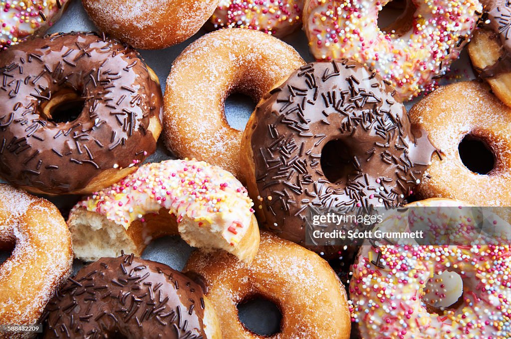 Ring doughnuts covered in icing and sprinkes