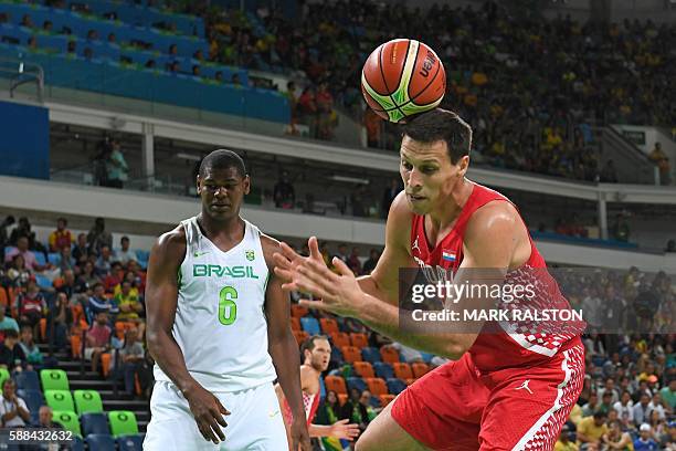 Croatia's centre Darko Planinic 9R) fails to catch a rebound next to Brazil's centre Cristiano Felicio during a Men's round Group B basketball match...