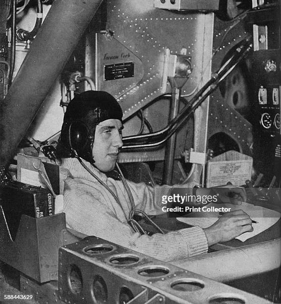 Flight engineer on board an aircraft, circa 1940 . The flight engineer watching his instrument board, which tells him how the engines are behaving....