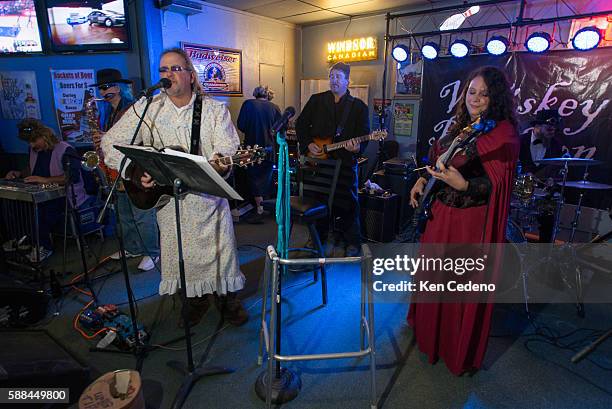 In Halloween costumes, the Big Bad Wolf and Little Miss Riding Hood jam with the band Whiskey Rebellion at a local bar The Sports Den in Williston,...