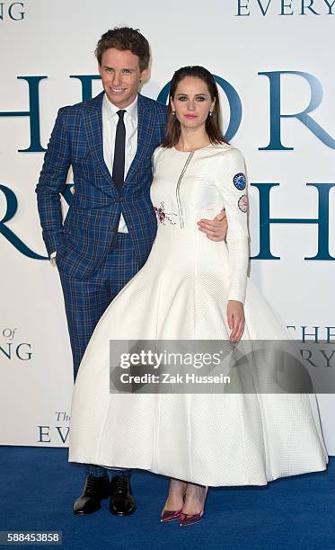 Felicity Jones, wearing a Christian Dior haute couture dress, and Eddie Redmayne arriving at the UK premiere of "The Theory of Everything" at the...