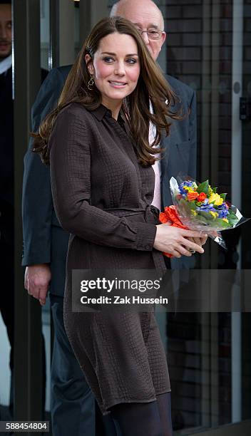 Catherine, Duchess of Cambridge, wearing a brown silk Hobbs dress, attends an event hosted by The Fostering Network to celebrate the work of foster...