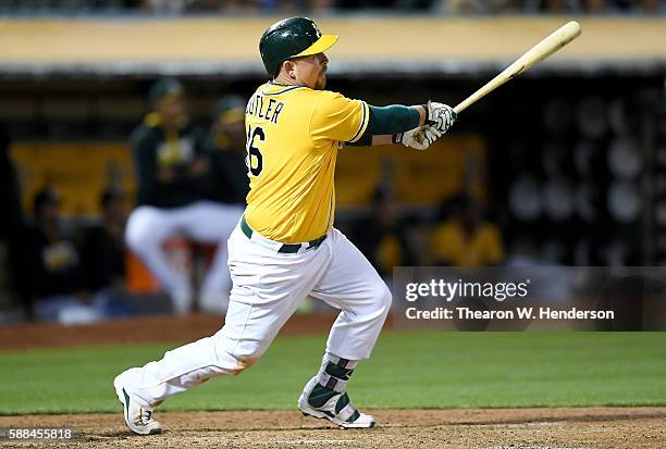 Billy Butler of the Oakland Athletics hits an rbi single scoring Stephen Vogt against the Baltimore Orioles in the bottom of the six inning at theh...