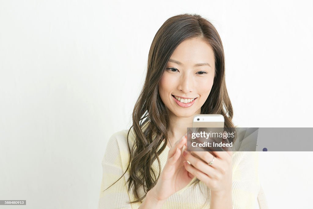 Young woman looking at smart phone