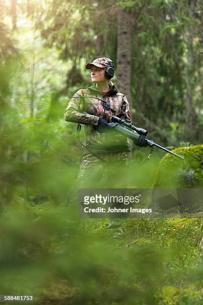 woman hunting in forest - spy hunter stock pictures, royalty-free photos & images