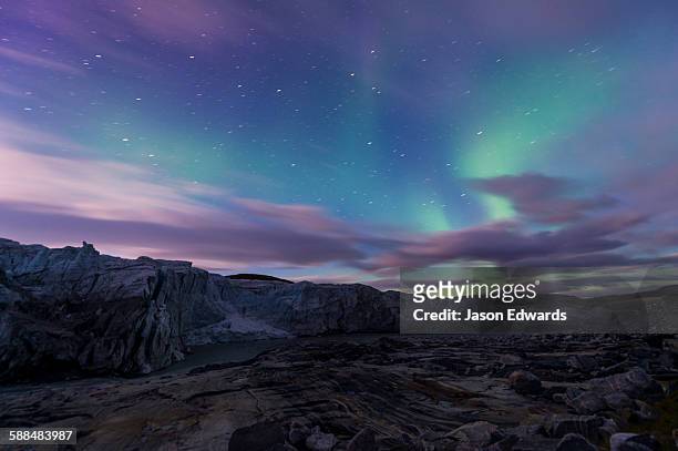 iridescent green northern lights dance in the sky above russell glacier. - kangerlussuaq bildbanksfoton och bilder