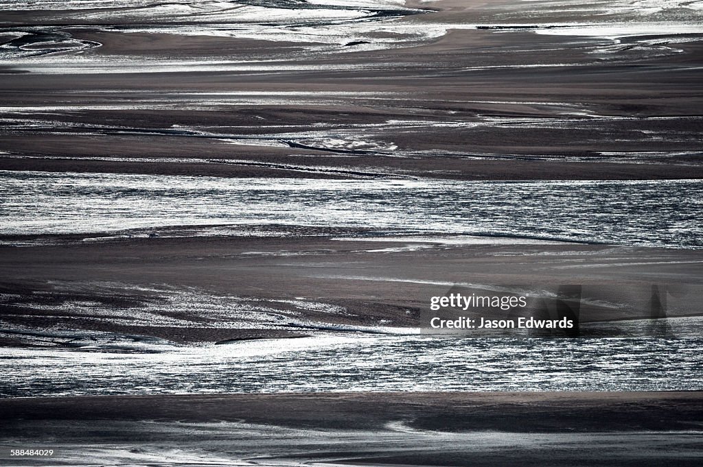 Sunrays illuminate a vast river floodplain carrying glacier run-off that creates quicksand plains.