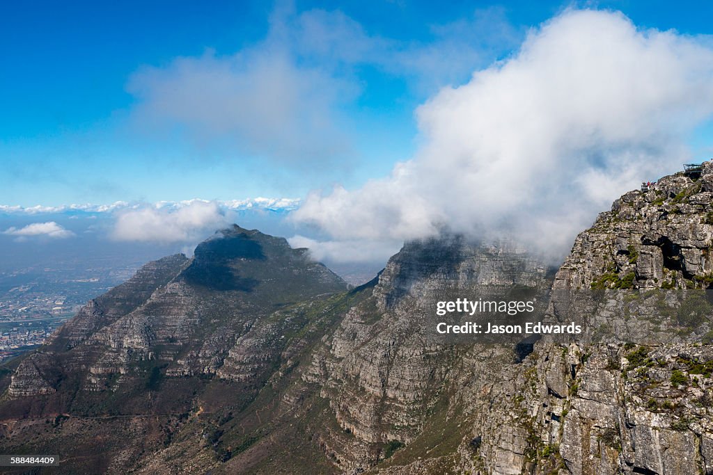 Clouds gather above the summit of Table Mountain with its sheer cliffs.