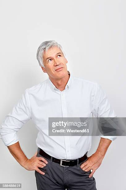 portrait of mature man looking up in thought - white shirt stock pictures, royalty-free photos & images