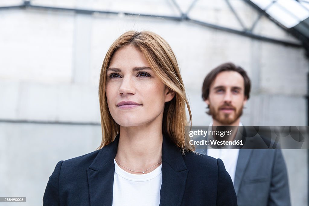 Portrait of businesswoman with her partner in the background