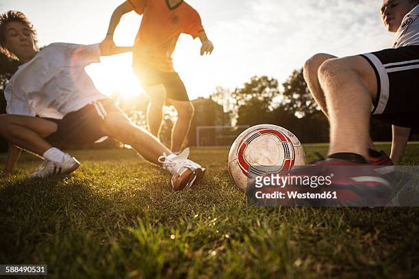 sliding tackle on soccer pitch - tackling photos et images de collection
