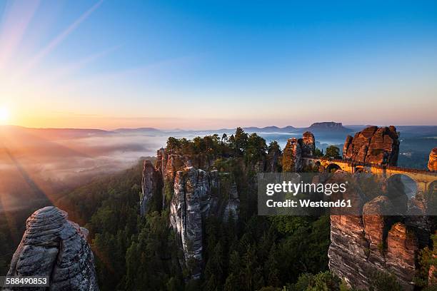 germany, saxony, saxon switzerland national park, elbe sandstone mountains and bastei bridge at sunrise - elbsandsteingebirge stock-fotos und bilder