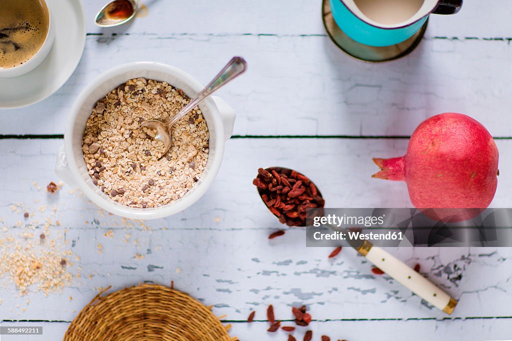 Quinoa breakfast bowl, rice milk, pomegranate, goji berries and coffee