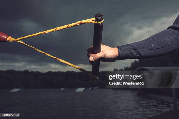 hand of young wakeboarder holding handle - rope handle stock pictures, royalty-free photos & images