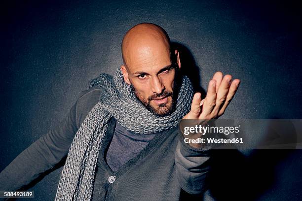 portrait of starring man in front of black background - studio portrait dark background stock-fotos und bilder