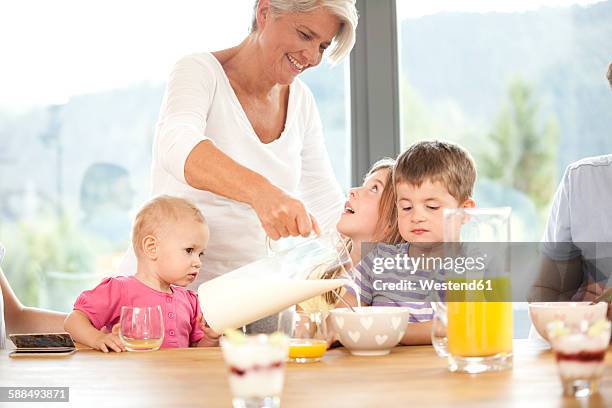 extended family having breakfast together - boy pajamas cereal stock pictures, royalty-free photos & images