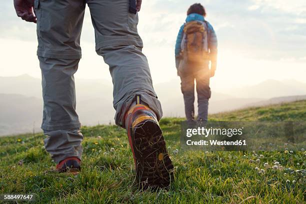 austria, tyrol, couple hiking at unterberghorn at sunrise - hiking boot stock pictures, royalty-free photos & images