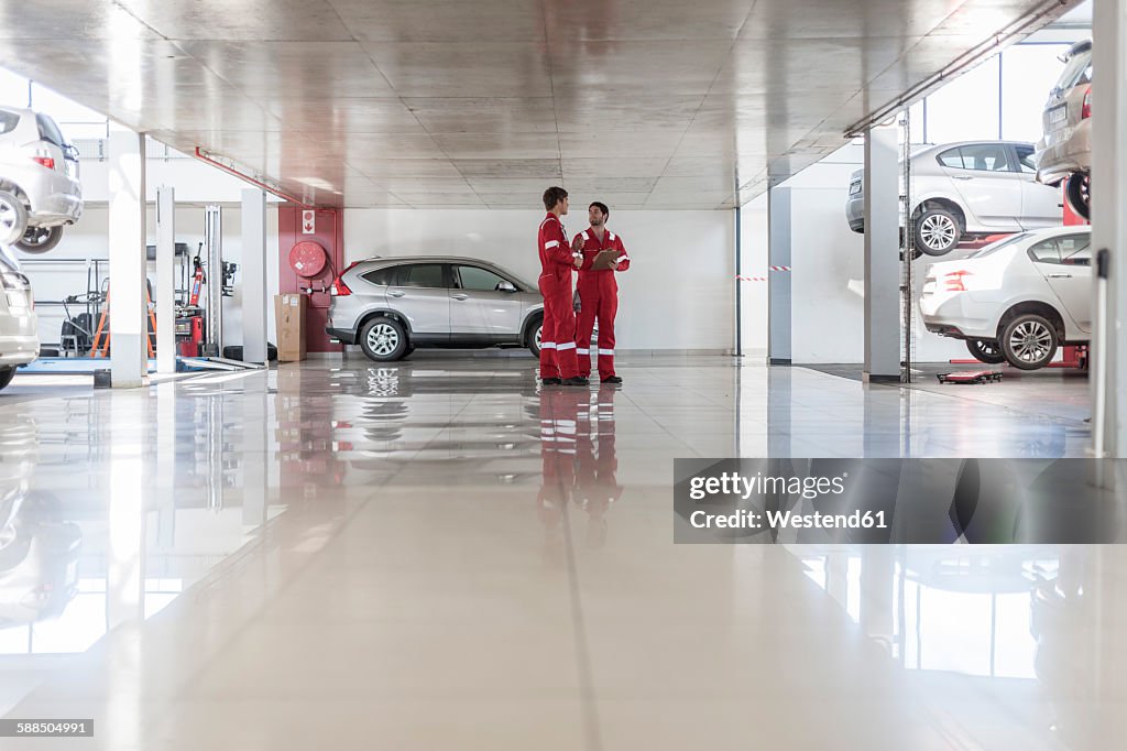 Car mechanics in repair garage