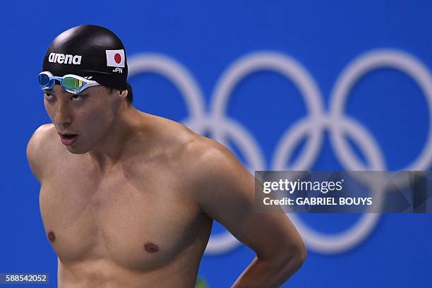 Japan's Takuro Fujii prepares to compete in a Men's 100m Butterfly heat during the swimming event at the Rio 2016 Olympic Games at the Olympic...