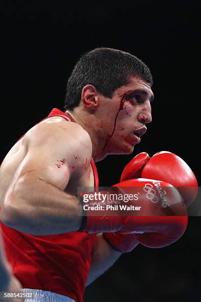 Vladimir Margaryan of Armenia suffers a cut in his fight against Roniel Iglesais of Cuba in their Mens Welterweight bout on Day 6 of the 2016 Rio...