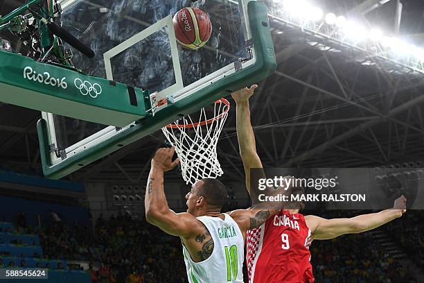 Brazil's small forward Alex Garcia and Croatia's forward Dario Saric go for a rebound during a Men's round Group B basketball match between Brazil...