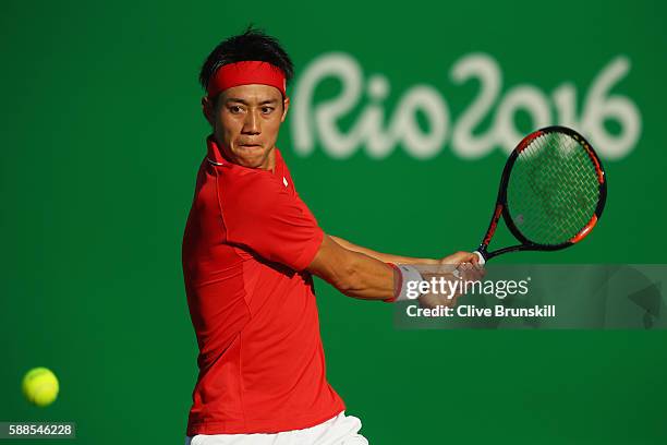 Kei Nishikori of Japan plays a backhand during the men's singles third round match against Andrej Martin of Slovakia on Day 6 of the 2016 Rio...