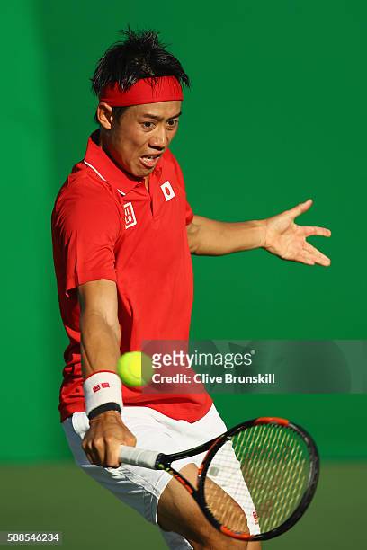 Kei Nishikori of Japan plays a backhand during the men's singles third round match against Andrej Martin of Slovakia on Day 6 of the 2016 Rio...