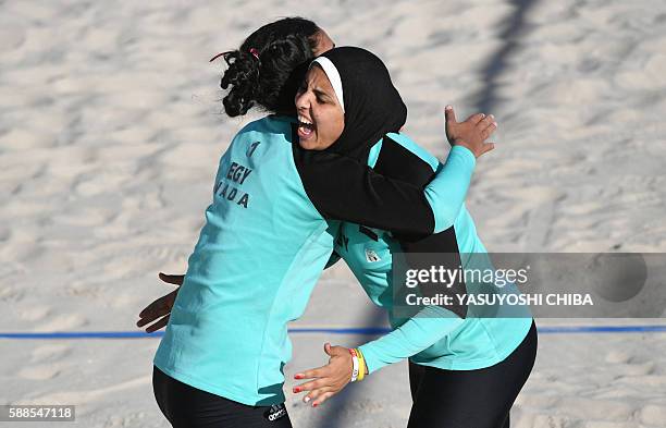 Egypt's Nada Meawad and Doaa Elghobashy celebrate after winning a point during the women's beach volleyball qualifying match between Canada and Egypt...