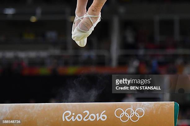 Japan's Asuka Teramoto competes in the beam event of the women's individual all-around final of the Artistic Gymnastics at the Olympic Arena during...