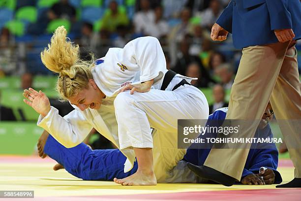 Kayla Harrison celebrates after defeating France's Audrey Tcheumeo during their women's -78kg judo contest gold medal match of the Rio 2016 Olympic...