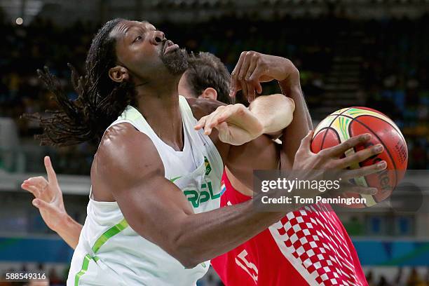 Miro Bilan of Croatia fouls Nene Hilario of Brazil during the Men's Basketball - Preliminary Round Group B Brazil vs Croatia on Day 6 of the Rio 2016...