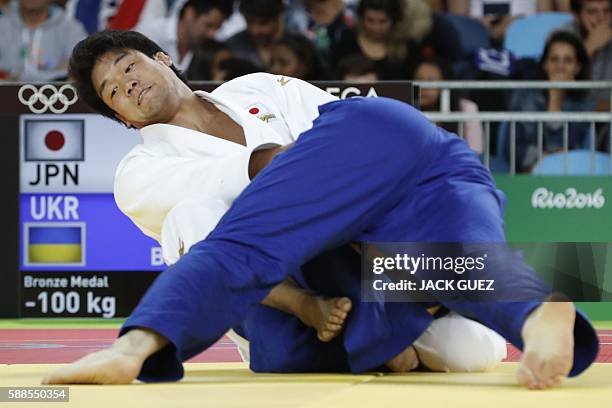 Japan's Ryunosuke Haga competes with Ukraine's Artem Bloshenko during their men's -100kg judo contest bronze medal B match of the Rio 2016 Olympic...