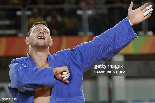 Czech Republic's Lukas Krpalek celebrates after defeating Azerbaijan's Elmar Gasimov during their men's -100kg judo contest gold medal match of the...