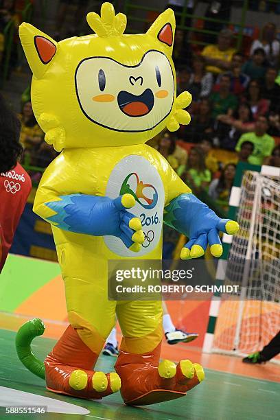 Performer dressed as Rio 2016 Olympic Games mascot Vinicius dances during a break of the men's preliminaries Group B handball match Brazil vs Germany...