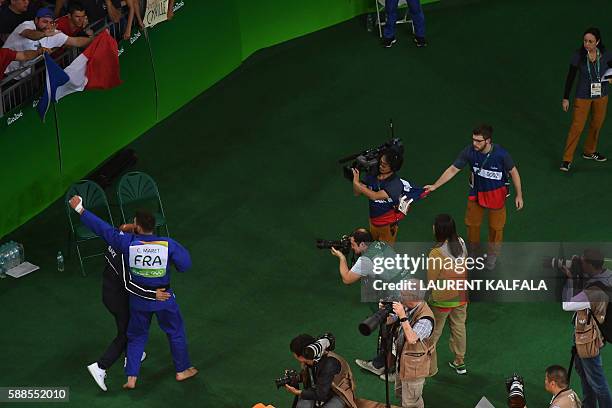 France's Cyrille Maret celebrates with France supporters after defeating Germany's Karl-Richard Frey during their men's -100kg judo contest bronze...