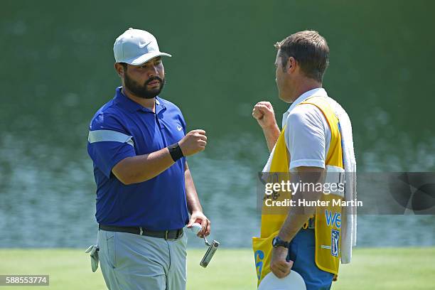 Spaun fist bumps his caddie after finishing his round on the ninth hole during the first round of the Web.com Tour Price Cutter Charity Championship...