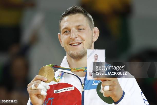 Gold medallist Czech Republic's Lukas Krpalek celebrates on the podium of the men's -100kg judo contest of the Rio 2016 Olympic Games in Rio de...
