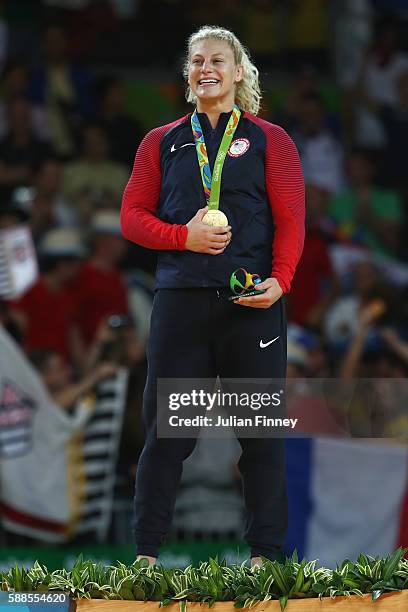 Gold medalist, Kayla Harrison of the United States celebrates on the podium after defeating Audrey Tcheumeo of France during the women's -78kg gold...