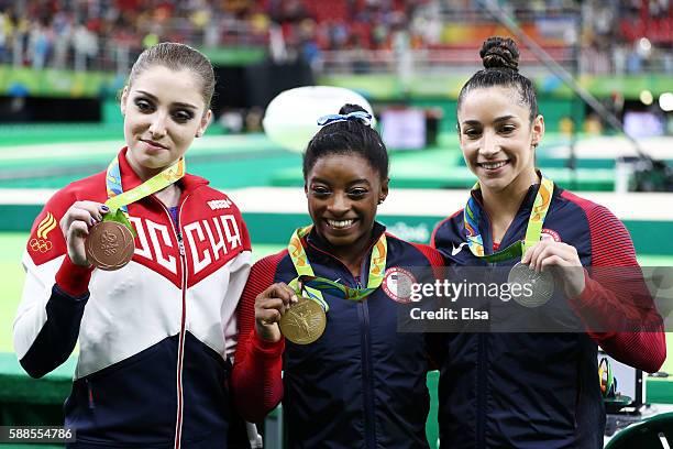 Bronze medalist Aliya Mustafina of Russia, gold medalist Simone Biles of the United States and silver medalist Alexandra Raisman of the United States...