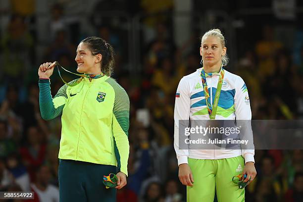Bronze medalists Mayra Aguiar of Brazil and Anamari Velensek of Slovenia celebrate on the podium after the women's -78kg bronze medal judo contest on...