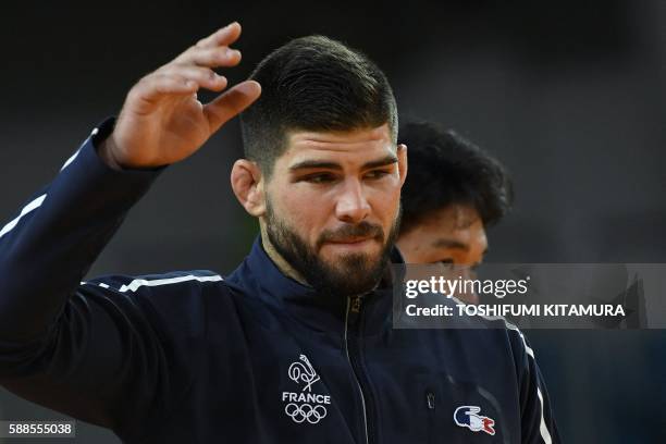 Bronze medallists France's Cyrille Maret and Japan's Ryunosuke Haga celebrate on the podium of the men's -100kg judo contest of the Rio 2016 Olympic...